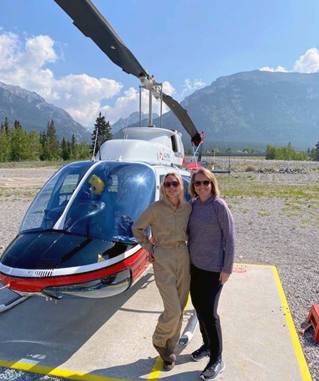 Dr. Madsen on a helicopter tour in Canada with a 24-year old female pilot. Walking the walk everywhere she goes.